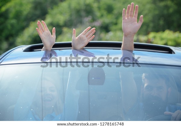 Eco\
friendly fuel. Hands gesturing in open car hatch. Travelling by\
car. Enjoying road trip. Automobile transport. Eco friendly and\
sustainable travel. Sustainable or green\
transport.