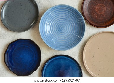 eco friendly handmade ceramic tableware top view with copy space for text and design, clay empty plate flat lay, cutlery and table setting, minimalism and ceramics tableware