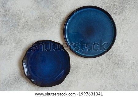 eco friendly handmade ceramic tableware top view with copy space for text and design, clay empty plate flat lay, cutlery and table setting, minimalism and ceramics tableware