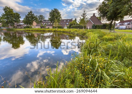 Eco friendly lakeside with gentle slope to stimulate growth of wildflowers and swamp vegetation in a recreational park in Soest, Netherlands