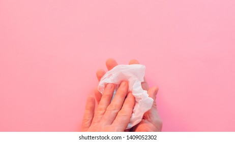 Eco Friendly Material. Biodegradable Waste. Man Wiping Hands With Cellulose Tissue Over Peach Color Background. Copy Space.