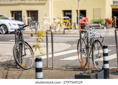Eco friendly micro mobility showcase featuring parked push bikes next to asphalt roadway infrastructure and modern vehicular traffic