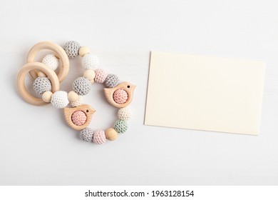 Eco Friendly Organic Newborn Teethers And Empty Card Mockup. Template For Baby Shower Invitation