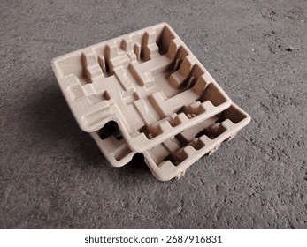 Eco friendly packaging: stack of molded pulp trays for protecting electronics or fragile goods.