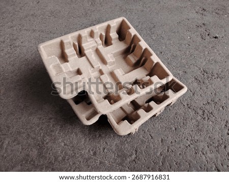 Eco friendly packaging: stack of molded pulp trays for protecting electronics or fragile goods.