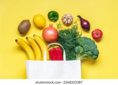 Eco friendly paper shop bag with raw organic green vegetables isolated on yellow background Flat lay, top view Zero waste, plastic free concept Healthy clean eating diet and detox, agriculture - Powered by Shutterstock