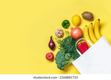 Eco friendly paper shop bag with raw organic green vegetables isolated on yellow background Flat lay, top view Zero waste, plastic free concept Healthy clean eating diet and detox, agriculture concept - Powered by Shutterstock