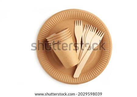 Eco - friendly plate with fork and glasses isolated on white background. Disposable tableware. Top view