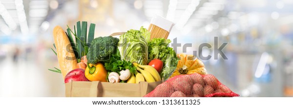 Eco friendly reusable shopping bag filled with\
food and vegetables