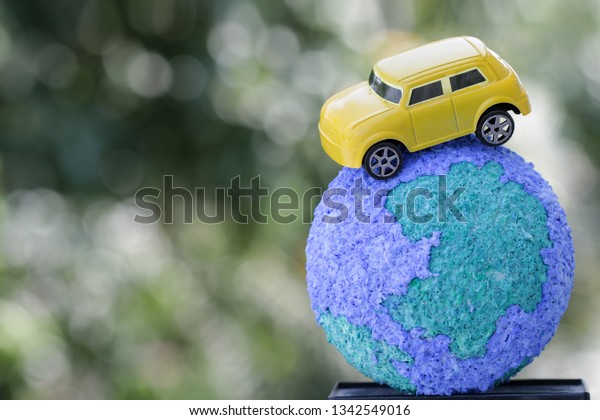 Eco friendly\
Save world concept. Yellow car on Paper Mache Craft Earth globe\
Natural background. Ideas of earth maintenance by reducing energy\
consumption, Travel around the\
world