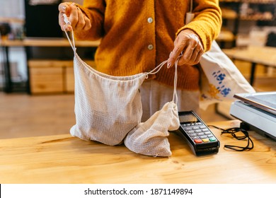 Eco Friendly Shopper Bag In Female's Hands On Wooden Counter At Zero Waste Plastic Free Grocery Store.