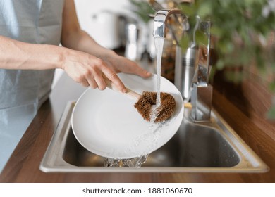 Eco Friendly Supplies Concept. Cropped View Of Woman Washing Plate In Sink, Using Zero Waste Coconut Brush, Standing On Kitchen, Making Daily Routine Cleaning At Home