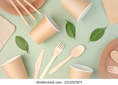 Eco - Friendly Tableware on Green Background. Top View. Plastic free Set of Brown Paper Utensil. Street Food Recyclable Packaging. Zero waste Paperware. Mockup. Disposable Take out Cup, wooden cutlery - Powered by Shutterstock