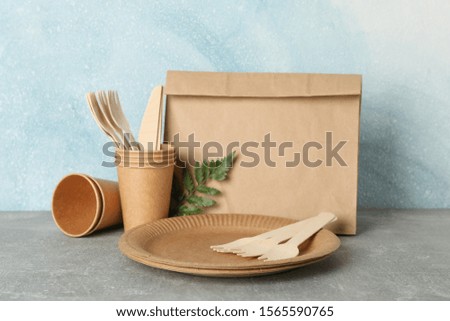 Eco - friendly tableware on grey table, space for text