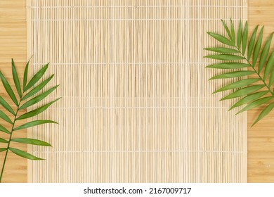 Eco friendly, wooden background. Empty wooden board with natural mat and palm leaves, flat lay. Mock up for display or montage of spa relax products, dishes, food or cosmetics - Shutterstock ID 2167009717