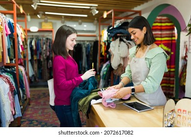 Eco Friendly Young Woman Buying Second Hand Clothes At The Thrift Store 