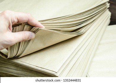 Eco Kraft Paper Sheet On The Background Of A Stack Of Paper. Environmentally Friendly Packaging.