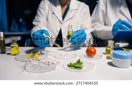 Eco laboratory microbiology. Sample in a Microscope and comparing a plant or herb in test tube or glassware. Natural product and organic cosmetic health care. 