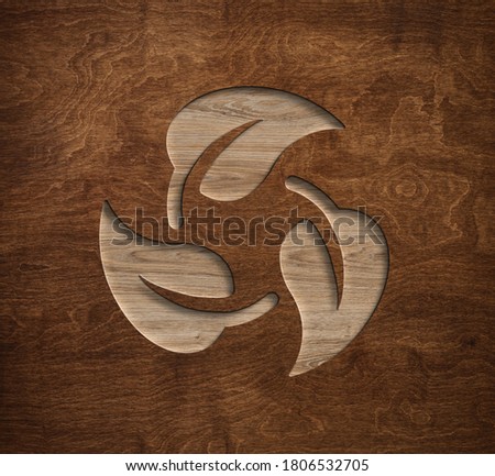 Eco leaves recycling triangle symbol engraved in wooden board