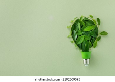 Eco Lightbulb From Green Leaves Top View. Renewable And Saving Energy Concept.
