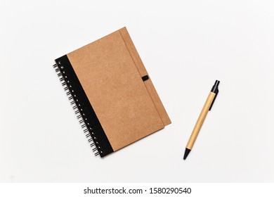 Eco Moleskine Notebook And Pen On White Background, Isolated