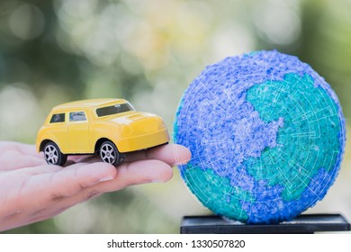 Eco Save World Environment / Travel Sport Concept : Miniature Figure Car On Hands Near Paper Mache Craft Earth Globe Natural Background. Environmentally Nature Friendly Ecology With Green Background