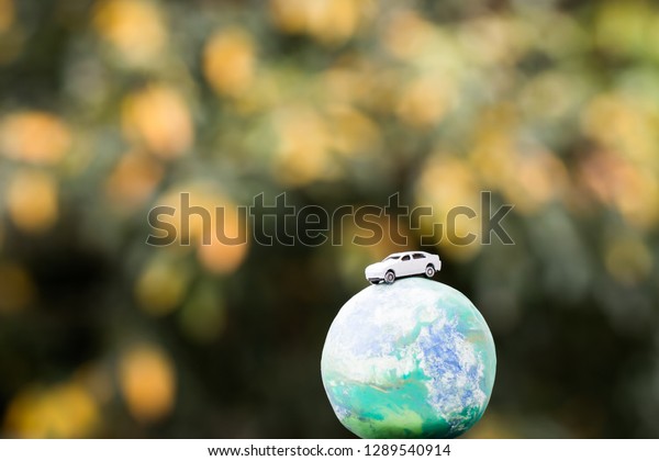 Eco save world environment /\
Travel sport Concept : Miniature figure car on world global model,\
Environmentally nature friendly ecology with yellow\
background