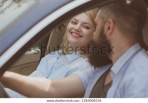 Eco transportation. Couple in love travel by
automobile transport. Loving couple enjoy sustainable travel.
Bearded man and sexy woman driving car. Using sustainable transport
for zero pollution.