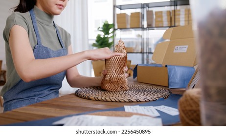 Eco vendor go green packaging parcel carton box in net zero waste store asian seller retail shop. Earth care day small SME owner asia people wrap reuse brown paper pack gift reduce plastic free order. - Shutterstock ID 2256450895