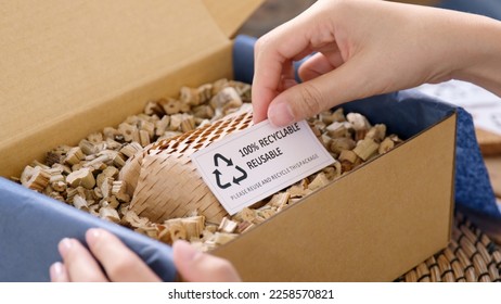 Eco vendor go green packaging parcel carton box in net zero waste store asian seller retail shop. Earth care day small SME owner asia people wrap reuse brown paper pack gift reduce plastic free order. - Shutterstock ID 2258570821