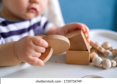 Eco Wood Toys. Baby Game. Little Clever Caucasian Child Playing Natural Toys On Highchair. Games For Early Development. Toy In Kids Hands Close Up