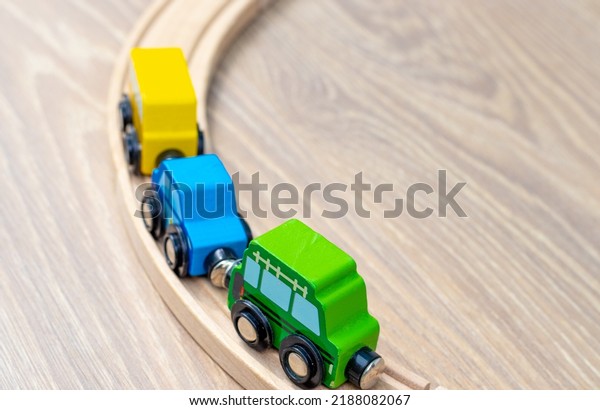 eco wooden toy train tracks for toddlers with cars\
arranged chaotic on laminate floor.activities for\
baby,kids.intelligent building blocks.train railway set.police\
car,autobus.direction sign,left\
turn
