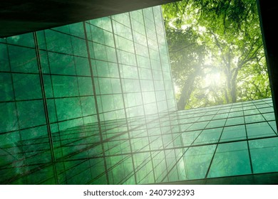 Eco-friendly building in modern city. Sustainable glass office building with trees for reducing CO2. Green architecture. Building with green environment. Sustainability corporate. Net zero emissions.