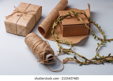 Eco-friendly Diy Christmas Presents Wrapping. Mindfulness About Natural New Year Decorations. Paper Roll, Rope Spool On White Table