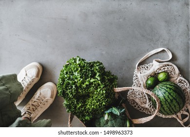 Eco-friendly lifestyle. Flat-lay of of grocery jute and net bags with fresh organic vegetables, greens, fruit from local farmers market, copy space. Zero waste, healthy, vegan and clean eating concept - Powered by Shutterstock