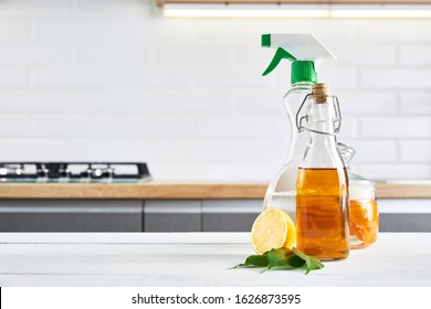 Eco-friendly natural cleaners: baking soda, soap, vinegar, salt, coffee, lemon and brush on wooden table. Kitchen background.