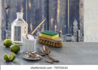 Eco-friendly natural cleaners baking soda, lemon and cloth on old wooden table and windows background,