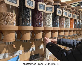 Eco-friendly Zero Waste Shop. Dispensers For Cereals, Nuts And Grains In Sustainable Plastic Free Grocery Store. Bio Organic Food. Shopping At Small Local Businesses. New Trend Alternative Buying.