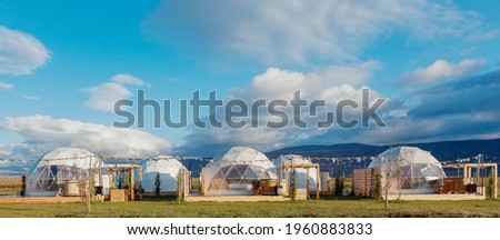eco-hotel glamping in a wonderful location with clouds.  Green, blue,  background. Cozy, camping, glamping, holiday, vacation lifestyle concept. Outdoors cabin, scenic background. Georgia