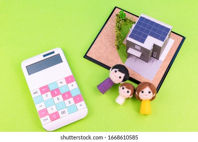 Eco-house With Solar Power System And Nuclear Family Doll