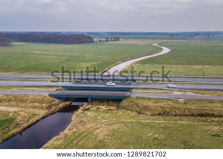 Ecological bridge over natural river with underpass for large animals