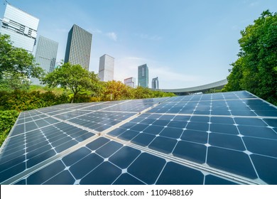 Ecological energy renewable solar panel plant with urban landscape landmarks - Shutterstock ID 1109488169