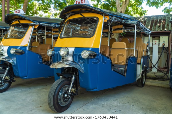 Ecological mode of transport on\
electric traction. Traditional taxi of Thailand\
tuk-tuk.