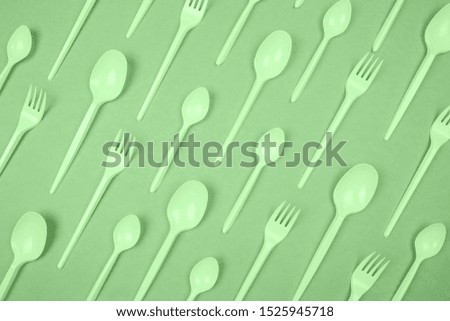 ecological pattern on a green background, plastic dishes friendly flat lay