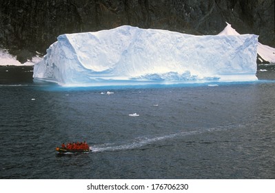 Ecological tourists in inflatable Zodiac boat in Errera Channel at Culverville Island, Antarctica