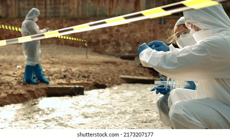 Ecologists sample water contaminated with dangerous, waterhazard toxins into tubes, Scientist or Biologist in protective waste water from industrial for analyze, problem environment, Testing toxic. - Shutterstock ID 2173207177