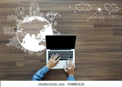 Ecology Concept, Creative Drawing On World Map Environment With Happy Family Stories Concept Idea, With Businessman Working On Laptop Computer PC On Wood Table, View From Above