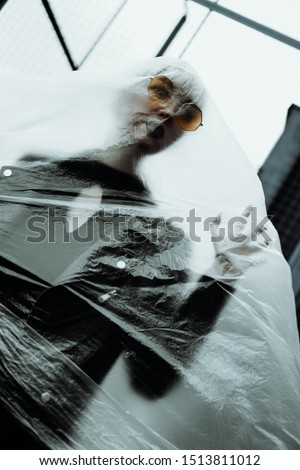 Similar – A woman disposes of red bin liners in the residual waste garbage can