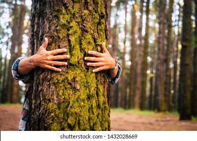 Ecology and environment concept with caucasian people woman hugging a green tree in the outdoor forest - nature and eco lifestyle - change the world - world's day and protection for life and planet