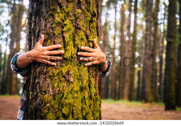 Ecology and environment concept with caucasian\
people woman hugging a green tree in the outdoor forest - nature\
and eco lifestyle - change the world - world\'s day and protection\
for life and planet